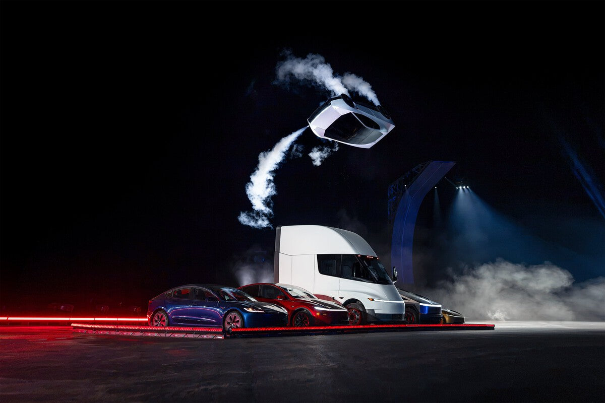Tesla Roadster prototype flying over a line of Tesla vehicles at the SpaceX Texas reveal