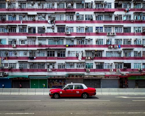 Best Phone Photo Captures Hong Kong Iconic Red Taxi and Dense Architecture - grandgoldman.com