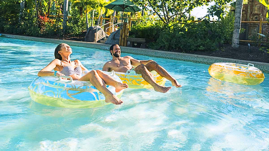 Best Palm Springs Hotels with Lazy River - happy couple in pool - Grand Goldman