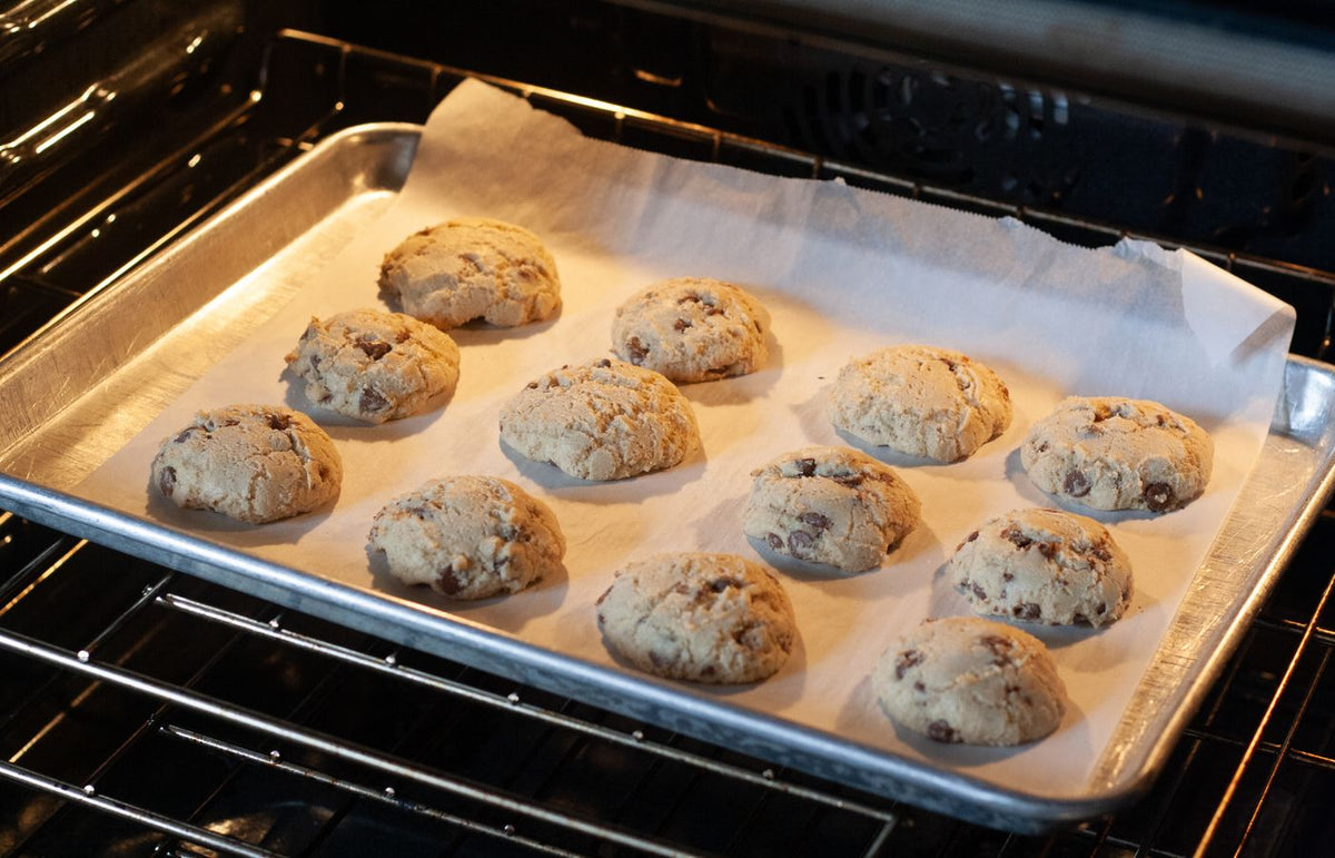 Delicious homemade chocolate chip cookies baking in an oven, fresh and ready to serve.