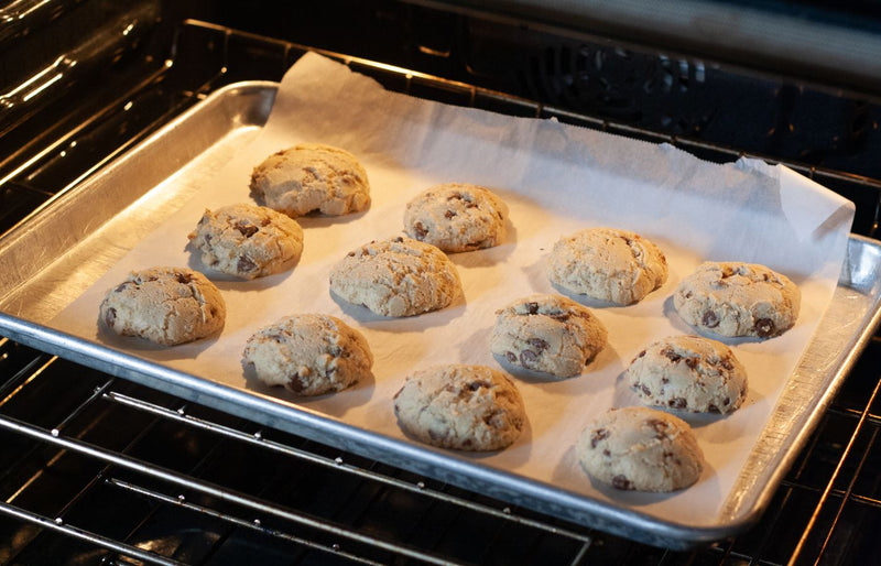 Delicious homemade chocolate chip cookies baking in an oven, fresh and ready to serve.