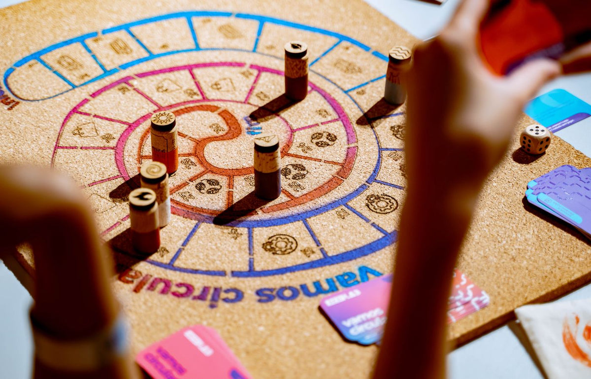 Players engaging in a vibrant strategy board game with colorful pieces and cards.