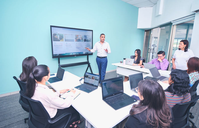 Team engaged in a presentation at a modern office using digital technology.