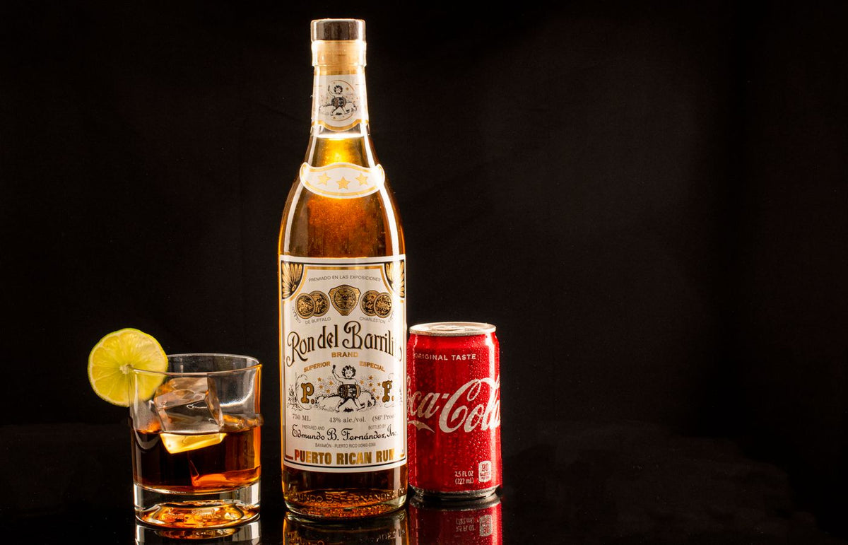Rum and Coke with lime on black background, featuring Puerto Rican rum.