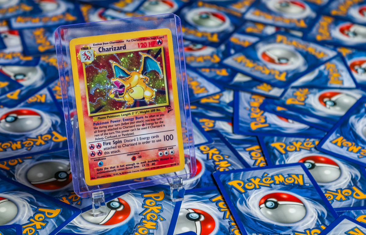 High-value Charizard Pokémon trading card surrounded by various other cards.