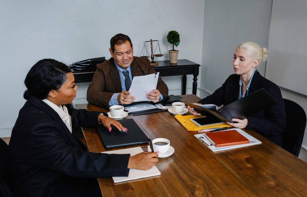 A diverse group of professionals discussing business strategies in an office setting.