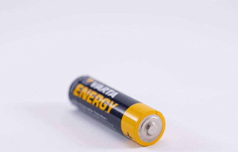 Detailed close-up of a single Varta Energy AA battery on a white background.