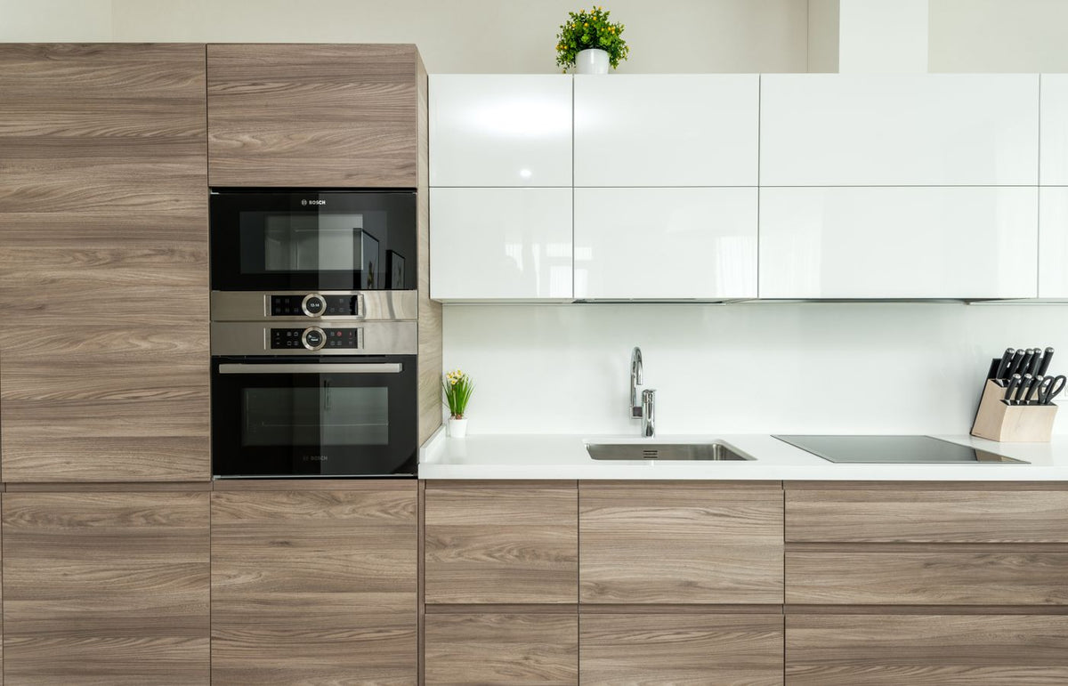 A sleek, contemporary kitchen featuring built-in appliances with minimalist design.