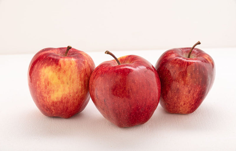 High-quality image of three fresh red apples against a white background.