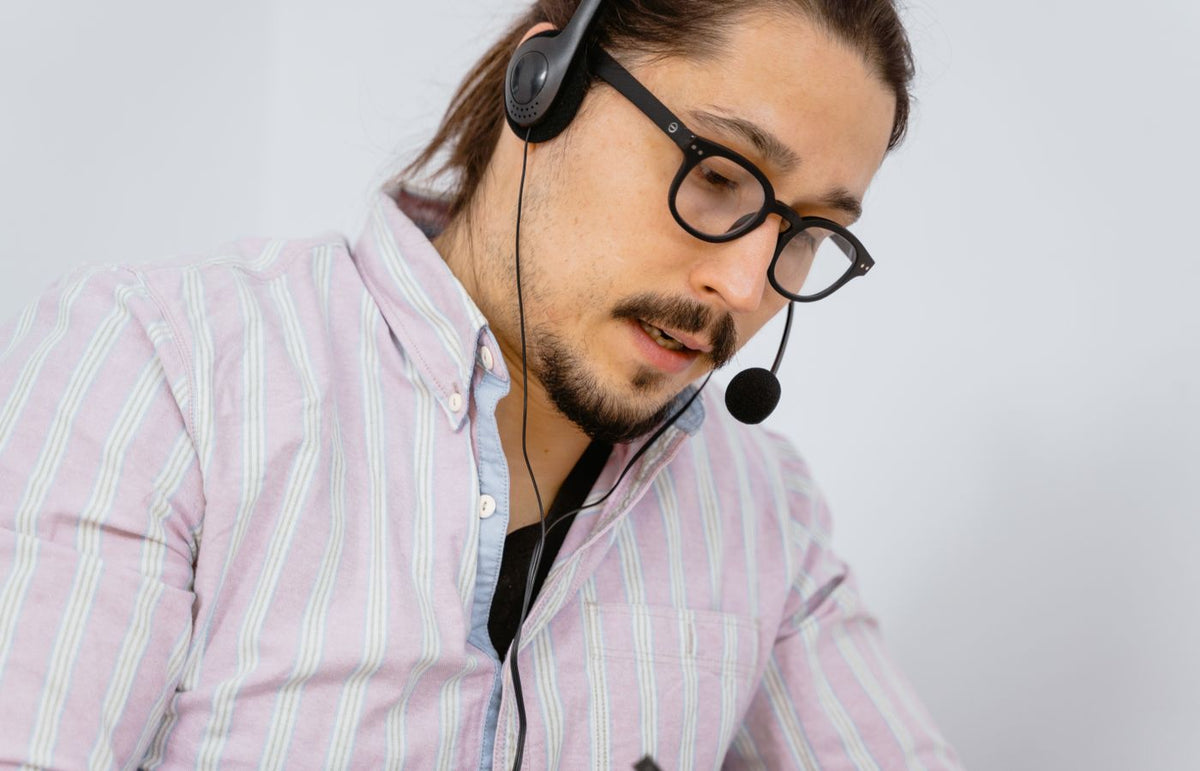 Focused call center agent with headset providing customer support.