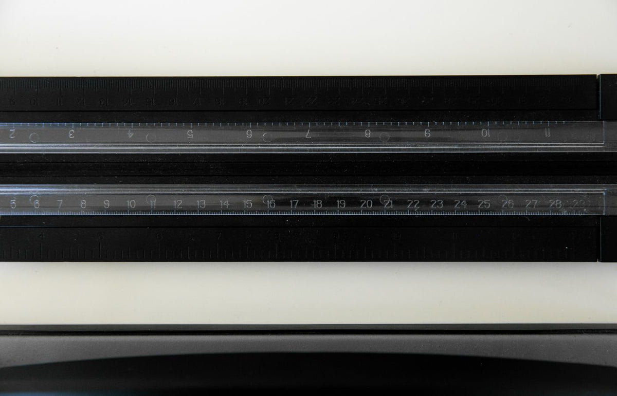 Close-up view of two transparent rulers showing both inches and centimeters.