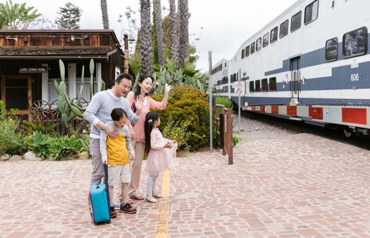 A family waves goodbye as a train departs, capturing a heartfelt moment at the station.