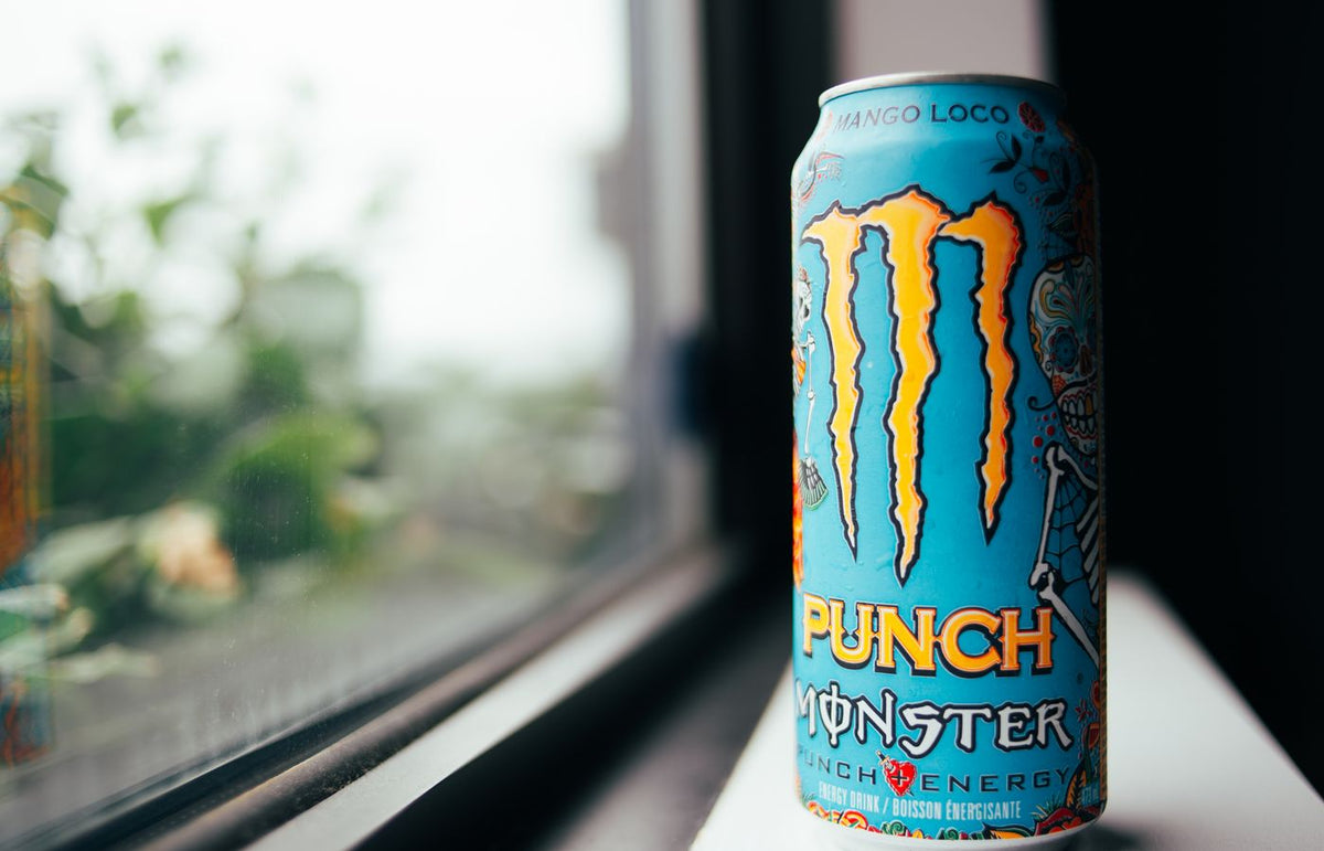 Vibrant image of a Mango Loco Monster Energy drink can on a windowsill.