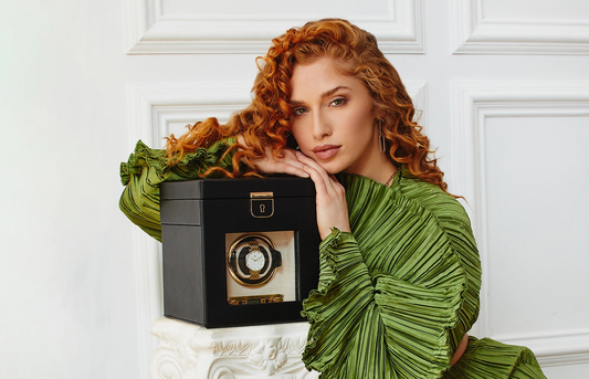 Red haired young woman in green shirts, with a black wolf watch winder.