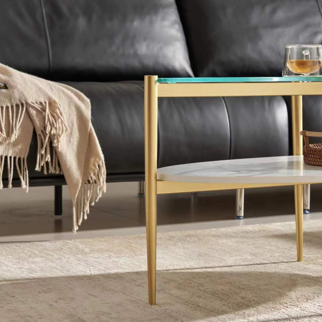 Shrine Oval Coffee Table, Mid-Century Modern Design, 2-Tier Structure, Clear Glass Top and White MDF Shelf, 47" D x 21" W x 17" H, Sleek Conical Metal Legs with Gold Finish