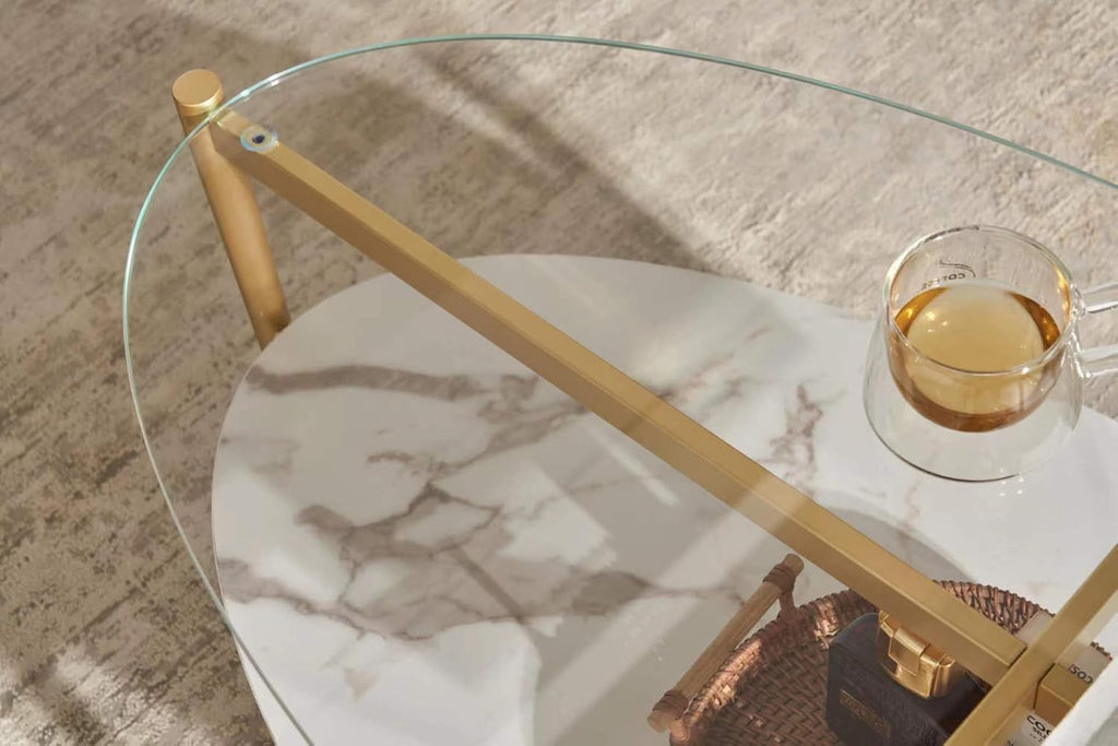 Shrine Oval Coffee Table, Mid-Century Modern Design, 2-Tier Structure, Clear Glass Top and White MDF Shelf, 47" D x 21" W x 17" H, Sleek Conical Metal Legs with Gold Finish