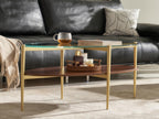 Shrine Oval Coffee Table, Mid-Century Modern Design, 2-Tier Structure, Clear Glass Top and White MDF Shelf, 47" D x 21" W x 17" H, Sleek Conical Metal Legs with Gold Finish
