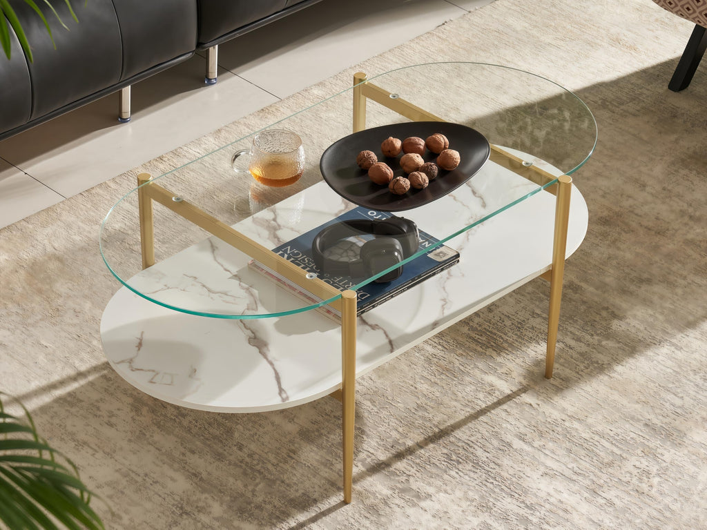 Shrine Oval Coffee Table, Mid-Century Modern Design, 2-Tier Structure, Clear Glass Top and White MDF Shelf, 47" D x 21" W x 17" H, Sleek Conical Metal Legs with Gold Finish