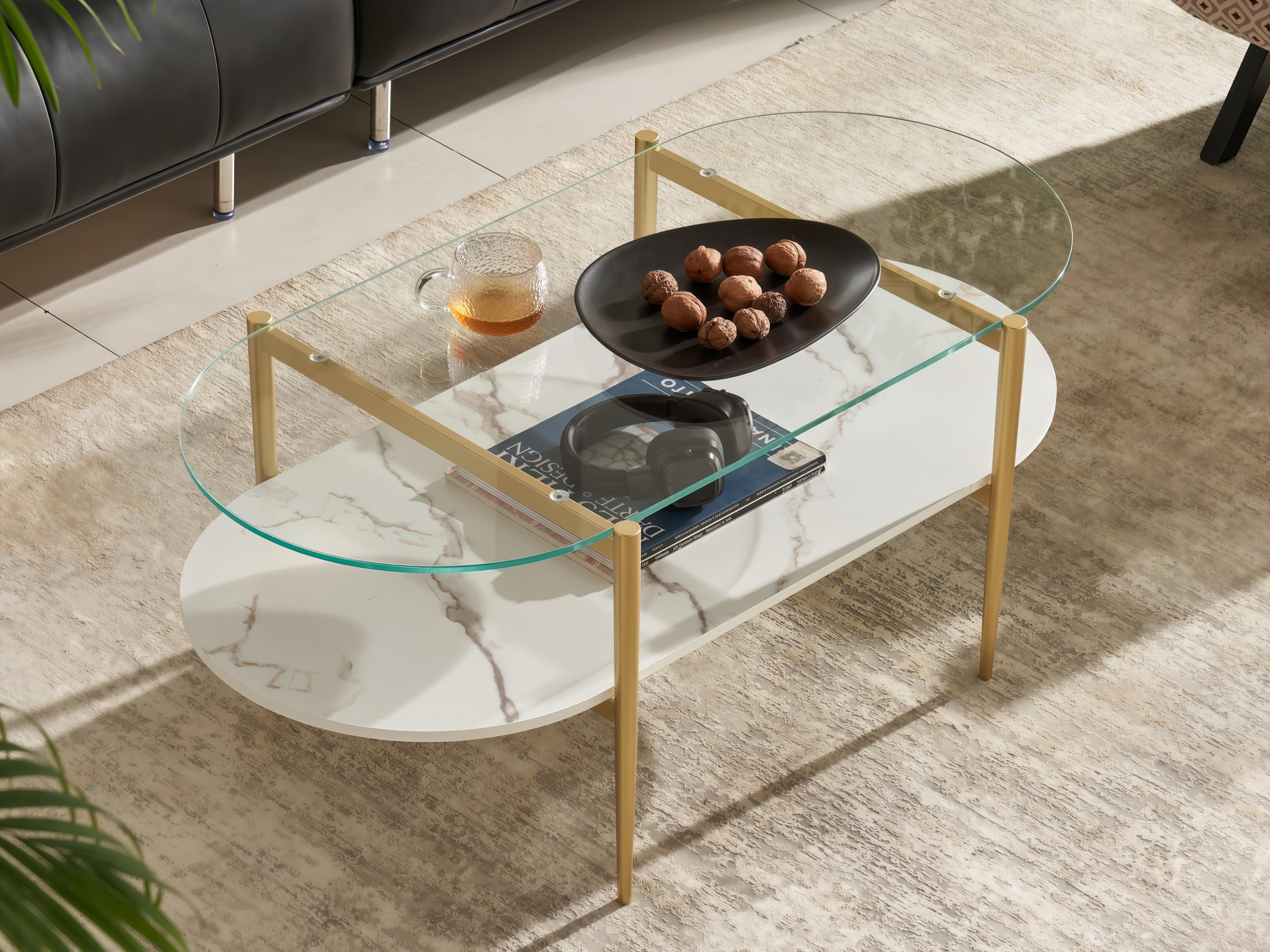 Shrine Oval Coffee Table, Mid-Century Modern Design, 2-Tier Structure, Clear Glass Top and White MDF Shelf, 47" D x 21" W x 17" H, Sleek Conical Metal Legs with Gold Finish