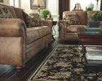 Signature Design by Ashley Larkinhurst Faux Leather Sofa with Nailhead Trim and 2 Accent Pillows, Brown