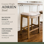 Maven Lane Adrien 26 Inch Counter Height Upholstered Backless Saddle Barstool in Natural Wood Finish with Wheat Cream Fabric Cushion Seat - Grand Goldman